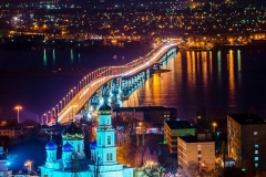 beautiful landscape of evening city Saratov with church and bridge through the Volga River, Russia